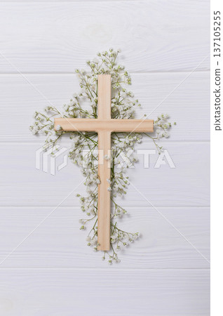 Wooden cross decorated with gypsophila flowers on a white vectical background for easter and good friday celebrations copyspace Wooden cross decorated with gypsophila flowers on a white vectical background for easter and good friday celebrations copyspace 137105255