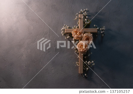 Wooden christian cross with pink roses and gypsophila flowers on a dark shadow wall representing faith and easter symbolizing faith, resurrection copyspace Wooden christian cross with pink roses and gypsophila flowers on a dark shadow wall representing faith and easter symbolizing faith, resurrection copyspace 137105257