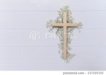 Wooden cross decorated with gypsophila flowers on a white background for easter and good friday celebrations copyspace Wooden cross decorated with gypsophila flowers on a white background for easter and good friday celebrations copyspace 137105335