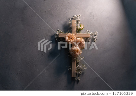 Wooden christian cross with pink roses and gypsophila flowers on a dark shadow wall representing faith and easter symbolizing faith, resurrection copyspace Wooden christian cross with pink roses and gypsophila flowers on a dark shadow wall representing faith and easter symbolizing faith, resurrection copyspace 137105339