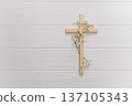 Wooden cross adorned with delicate white gypsophila flowers, symbolizing faith, resurrection, and honoring easter traditions copyspace 137105343