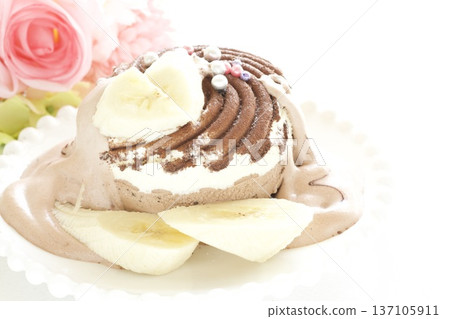 Ice cream decorated with banana and chocolate Ice cream decorated with banana and chocolate 137105911
