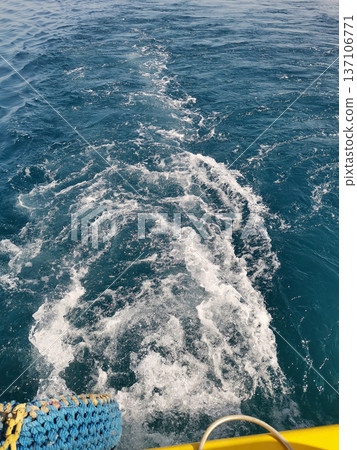 Boat wake on deep blue sea with ropes and yellow hull for nautical background and ocean texture wallpaper Boat wake on deep blue sea with ropes and yellow hull for nautical background and ocean texture wallpaper 137106771
