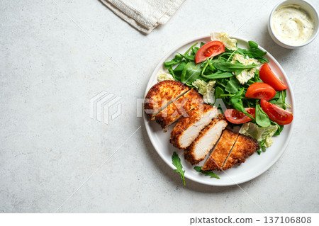 Breaded Chicken with vegetable salad 137106808
