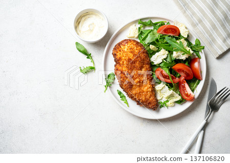 Breaded Chicken with vegetable salad 137106820
