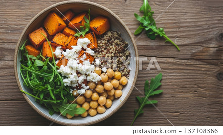 Quinoa and chickpea bowl with roasted squash arugula and feta for healthy lunch bowl and meal prep background 137108366