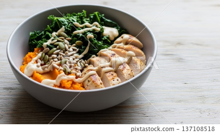 Side view grilled chicken and kale bowl with sweet potato mash and seed topping for healthy lunch background and restaurant menu image Side view grilled chicken and kale bowl with sweet potato mash and seed topping for healthy lunch background and restaurant menu image 137108518