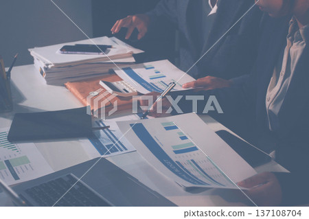 Professional photo of a person's hands reviewing a contract or legal document on a desk, for concepts of business, finance, and legal affairs Professional photo of a person's hands reviewing a contract or legal document on a desk, for concepts of business, finance, and legal affairs 137108704