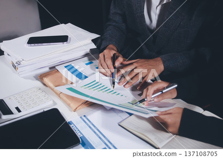 Professional photo of a person's hands reviewing a contract or legal document on a desk, for concepts of business, finance, and legal affairs Professional photo of a person's hands reviewing a contract or legal document on a desk, for concepts of business, finance, and legal affairs 137108705