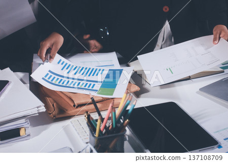 Professional photo of a person's hands reviewing a contract or legal document on a desk, for concepts of business, finance, and legal affairs Professional photo of a person's hands reviewing a contract or legal document on a desk, for concepts of business, finance, and legal affairs 137108709