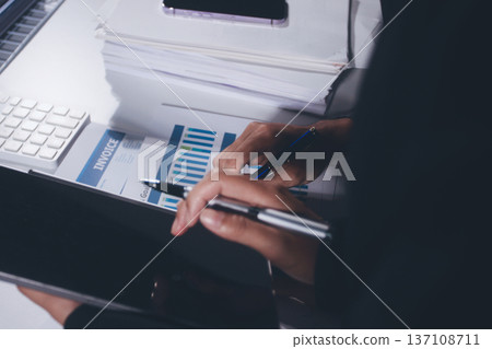 Professional photo of a person's hands reviewing a contract or legal document on a desk, for concepts of business, finance, and legal affairs Professional photo of a person's hands reviewing a contract or legal document on a desk, for concepts of business, finance, and legal affairs 137108711