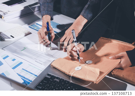 Professional photo of a person's hands reviewing a contract or legal document on a desk, for concepts of business, finance, and legal affairs Professional photo of a person's hands reviewing a contract or legal document on a desk, for concepts of business, finance, and legal affairs 137108713