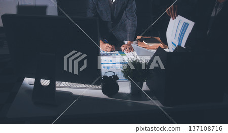 Professional photo of a person's hands reviewing a contract or legal document on a desk, for concepts of business, finance, and legal affairs 137108716