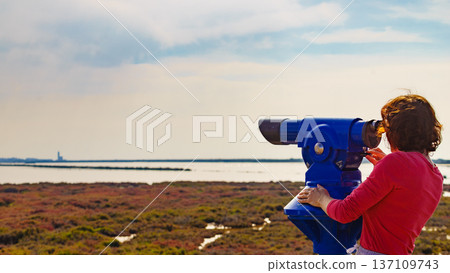Woman using tourist binoculars, Cabo de Gata, Spain Woman using tourist binoculars, Cabo de Gata, Spain 137109743