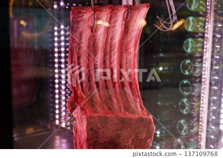 Dry Aged Rib of Beef Hanging in Display Case 137109768