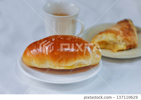 Shio Pan, Salzstangerl bread or Austria bread or Japanese bread with puff and hot tea Shio Pan, Salzstangerl bread or Austria bread or Japanese bread with puff and hot tea 137110629