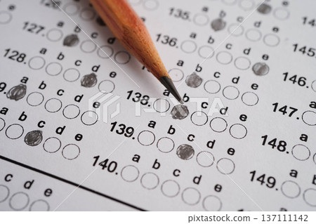 Answer sheets with pencil drawing fill to select choice, education concept. 137111142