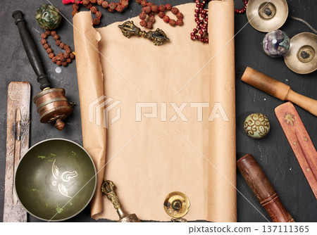 Religious objects for prayer and meditation, with a sheet of brown paper in the middle for writing. Religious objects for prayer and meditation, with a sheet of brown paper in the middle for writing. 137111365