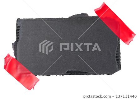 A torn piece of black cardboard is glued with red electrical tape on an isolated background A torn piece of black cardboard is glued with red electrical tape on an isolated background 137111440