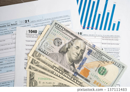 Tax form 1040 U.S. Individual Income Tax Return with dollar banknotes money. 137111483