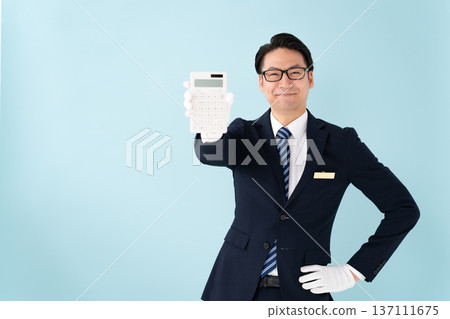 A man wearing white gloves holding a calculator is surprised A man wearing white gloves holding a calculator is surprised 137111675