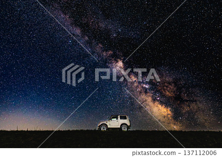 Night view of the Milky Way and Jimny-style vehicle. The contrast between the stars and the earth. Night view of the Milky Way and Jimny-style vehicle. The contrast between the stars and the earth. 137112006