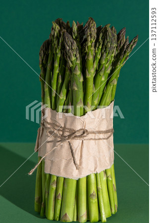 Asparagus bunch. Fresh spring vegetable food. Green background Asparagus bunch. Fresh spring vegetable food. Green background 137112593