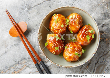Tasty tiger skin eggs topped with sesame seeds and green onions closeup in the bowl. Horizontal top view Tasty tiger skin eggs topped with sesame seeds and green onions closeup in the bowl. Horizontal top view 137114570