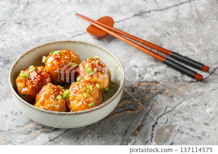 Chinese Tiger Skin Eggs or Hu Pi Dan, a delicious crispy dish with spicy sauce, green onions and sesame seeds, close-up in a bowl. Horizontal Chinese Tiger Skin Eggs or Hu Pi Dan, a delicious crispy dish with spicy sauce, green onions and sesame seeds, close-up in a bowl. Horizontal 137114575