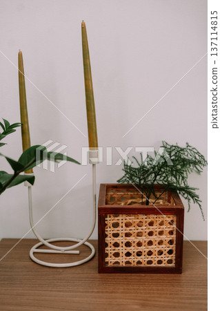 Modern Home Decor with Candles and Rattan Plant Pot 137114815