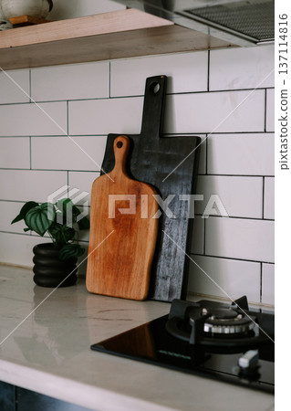 Modern Kitchen Countertop with Stylish Wooden Cutting Boards and Plant 137114816