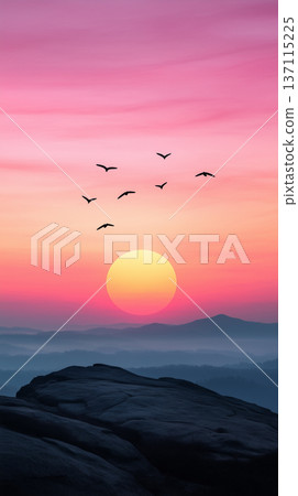 Vibrant purple and pink sunset over mountains with birds flying in a colorful sky 137115225