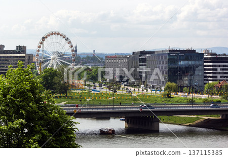 Krakow, May 13, 2023, A Ferris wheel along the Vistula River in Krakow Krakow, May 13, 2023, A Ferris wheel along the Vistula River in Krakow 137115385