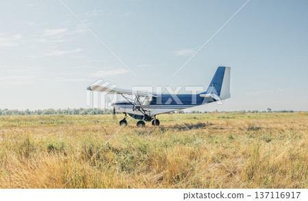 aircraft starting to take off or land on agricultural land, agriculture in motion, logistics concept, rural business, crop production. 137116917