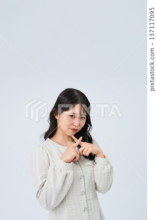 A young woman making an NG sign with her hand A young woman making an NG sign with her hand 137117095