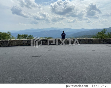 A person looking out at the view from a lookout point on Skyline Drive in the Blue Ridge Mountains (Virginia) A person looking out at the view from a lookout point on Skyline Drive in the Blue Ridge Mountains (Virginia) 137117370