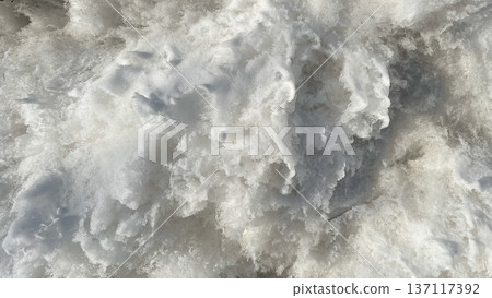 White melting snow texture with ice crystals and frozen water surface as a seasonal winter background. 137117392