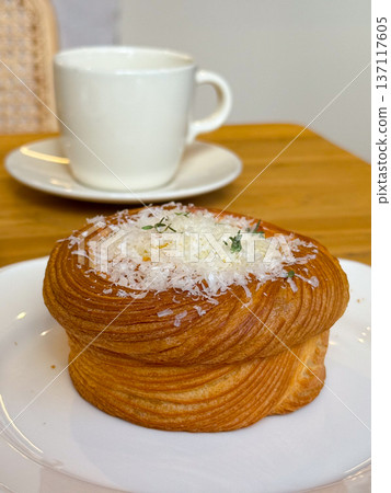 Gourmet pastry with grated cheese and herbs on a plate. Culinary presentation and fine dining. Gourmet pastry with grated cheese and herbs on a plate. Culinary presentation and fine dining. 137117605