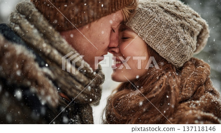 Couple sharing a kiss in a snowy setting during winter while enjoying the moment together Couple sharing a kiss in a snowy setting during winter while enjoying the moment together 137118146