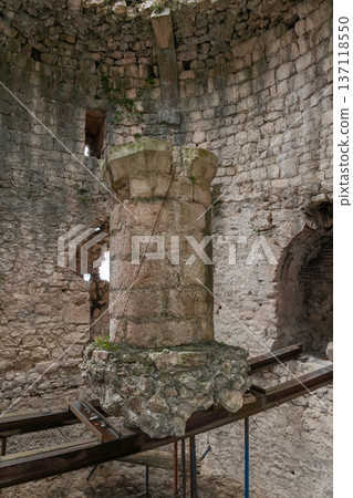 Stone pillar and arched window inside Anacopia fortress tower in Abkhazia with textured masonry walls, natural light, Historic architectural interior suitable for tourism marketing, heritage education Stone pillar and arched window inside Anacopia fortress tower in Abkhazia with textured masonry walls, natural light, Historic architectural interior suitable for tourism marketing, heritage education 137118550
