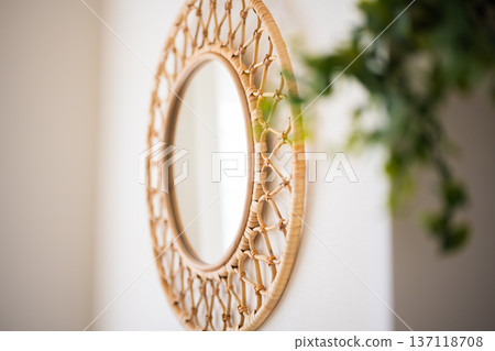rattan mirror hanging on the wall 137118708