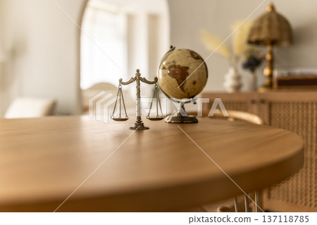 Scales and a globe on a desk Scales and a globe on a desk 137118785