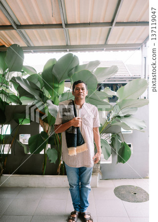 Muslim man carrying a prayer mat for his daily worship Muslim man carrying a prayer mat for his daily worship 137119047