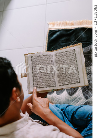 Man Studying Quran, Sacred Text of Islamic Faith Man Studying Quran, Sacred Text of Islamic Faith 137119062