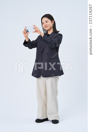 Young woman looking at smartphone screen Young woman looking at smartphone screen 137119267