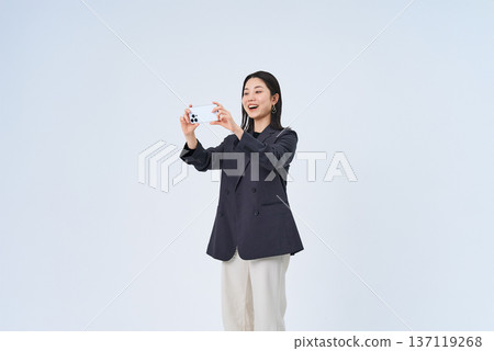 Young woman looking at smartphone screen Young woman looking at smartphone screen 137119268