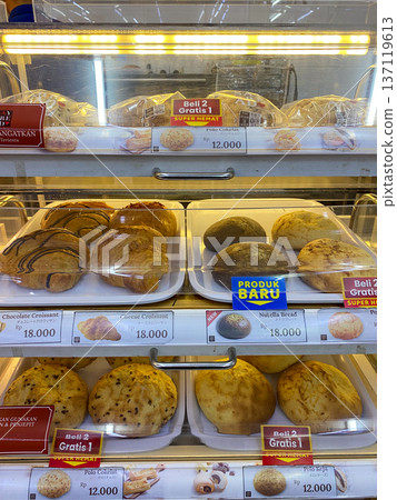 Jakarta, Indonesia - February 08 2026: Various selections of sweet breads like chocolate, cheese, and Say Bread croissants neatly arranged inside a bakery display case. Jakarta, Indonesia - February 08 2026: Various selections of sweet breads like chocolate, cheese, and Say Bread croissants neatly arranged inside a bakery display case. 137119613