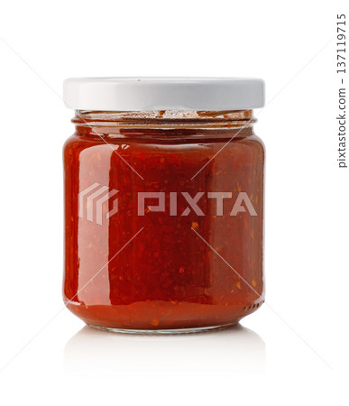 Spicy chili sauce in glass jar with white lid 137119715
