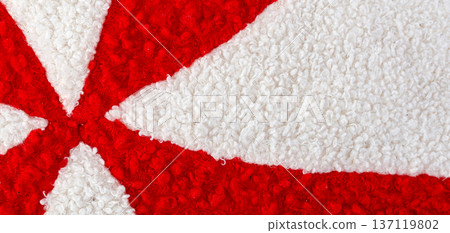 Red and white thick woolly fabric displaying abstract stripes 137119802
