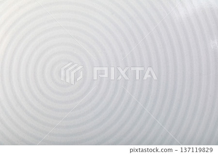 White ceramic plate displaying subtle ripple patterns White ceramic plate displaying subtle ripple patterns 137119829
